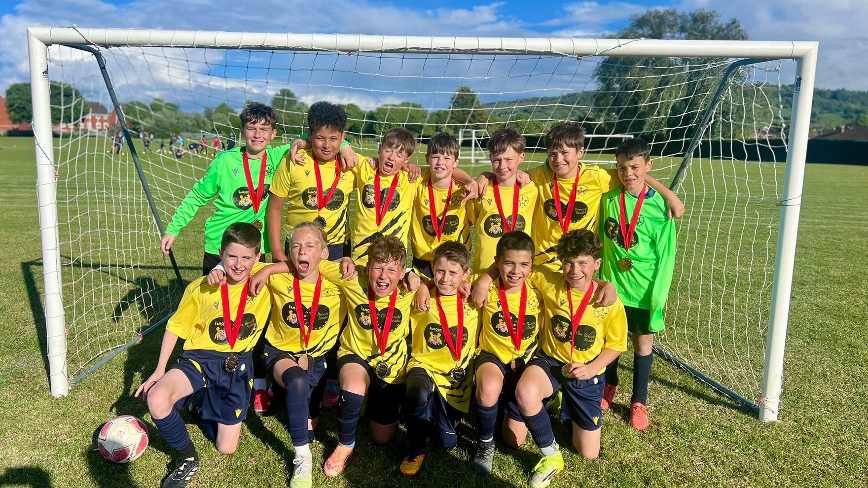 The Southside Star Cheetahs U11 squad with their medals in front of the goal after finishing CYFL U12 Division 2 runners-up