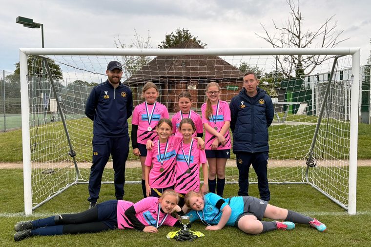 A Southside Star girls' team celebrating together with their trophy